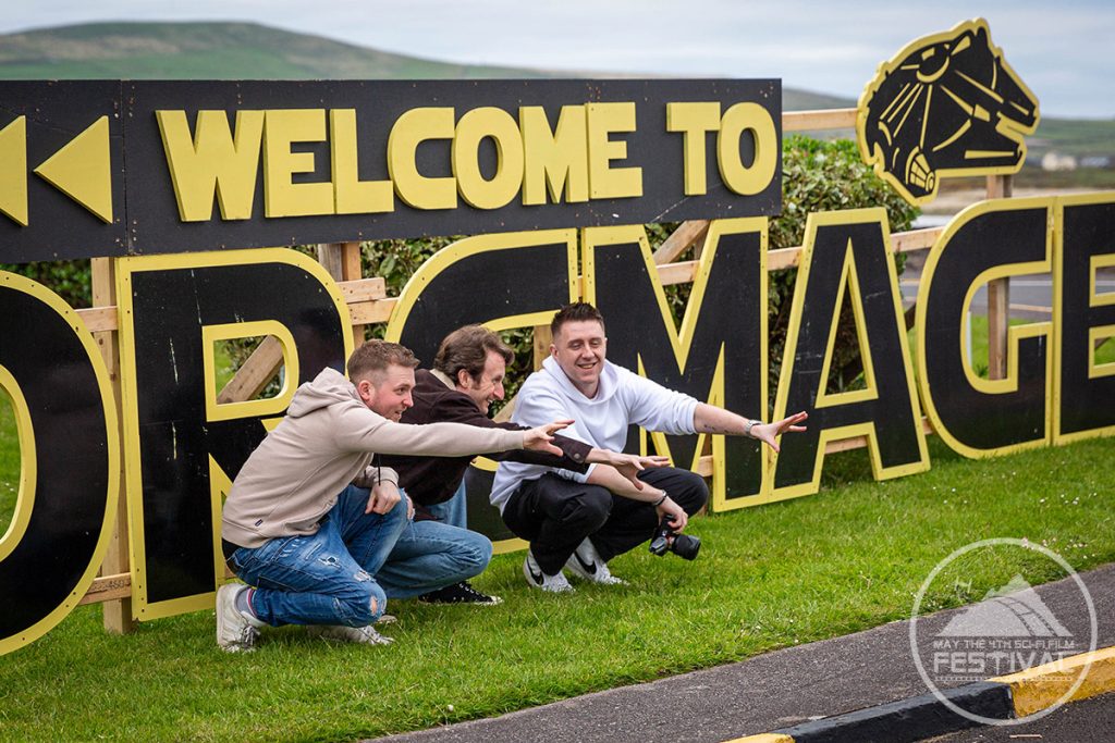 Three men posing with the Portmagee sign