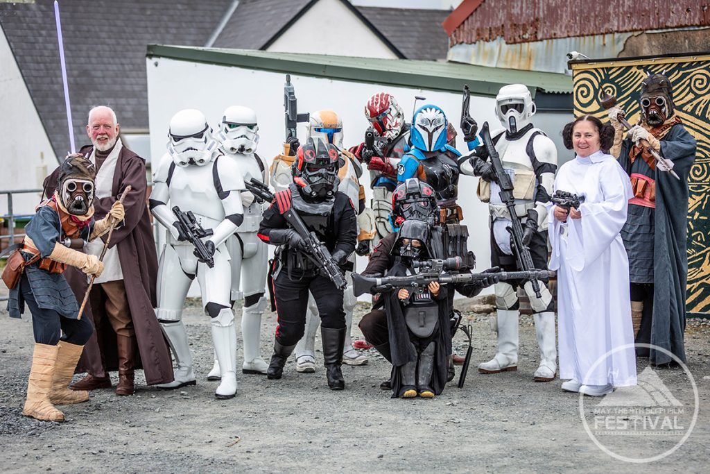 Storm troopers posing in front of a mural