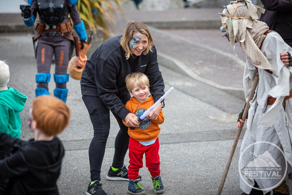 A child playing with a light saber