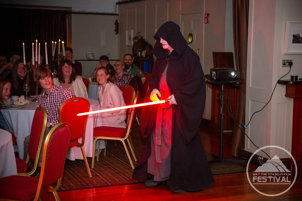 A character holding a red light saber