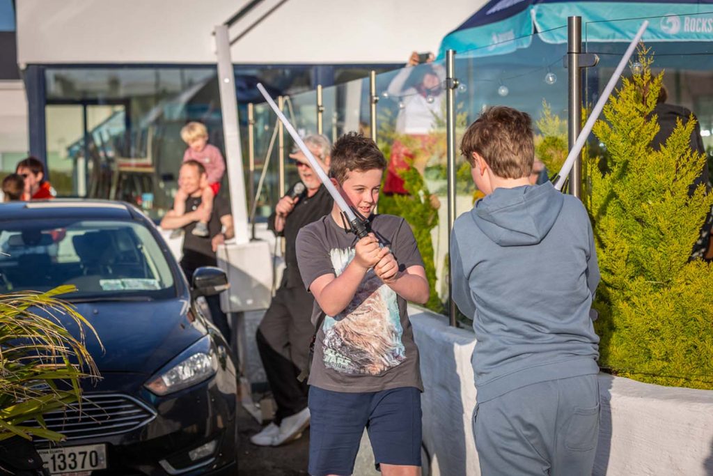 Two kids fighting with lightsabers