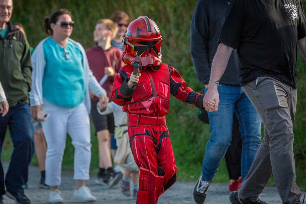 A young child dressed up as a red storm trooper