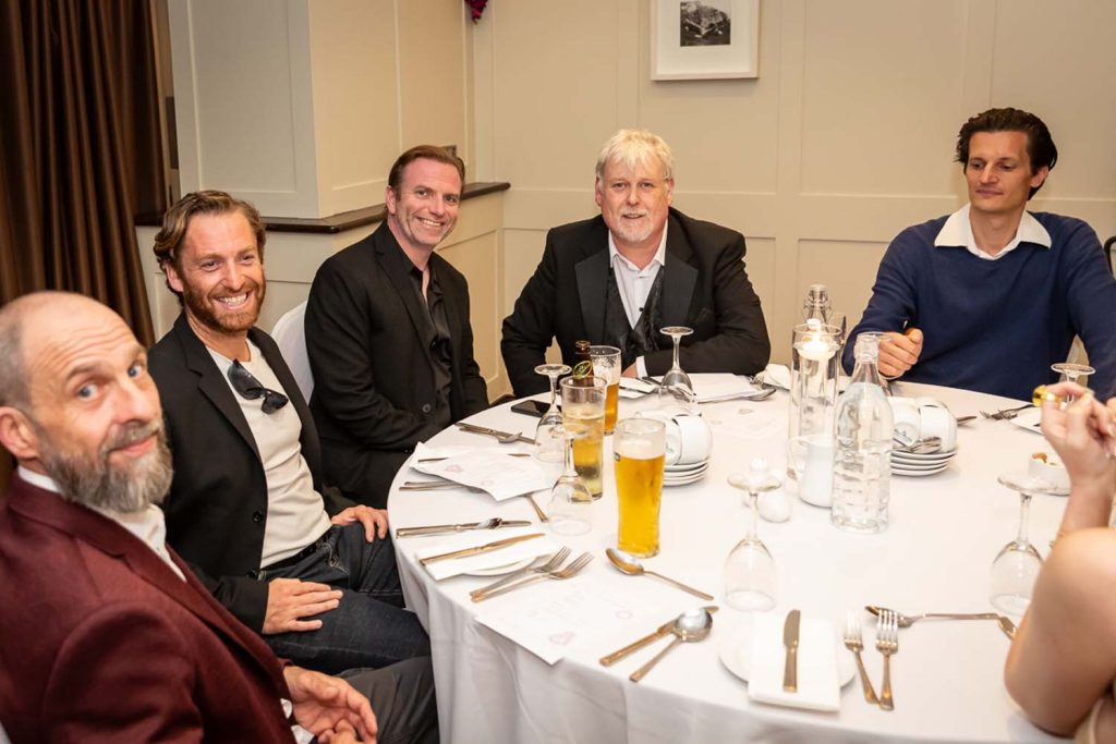 A table of men enjoying a conversation