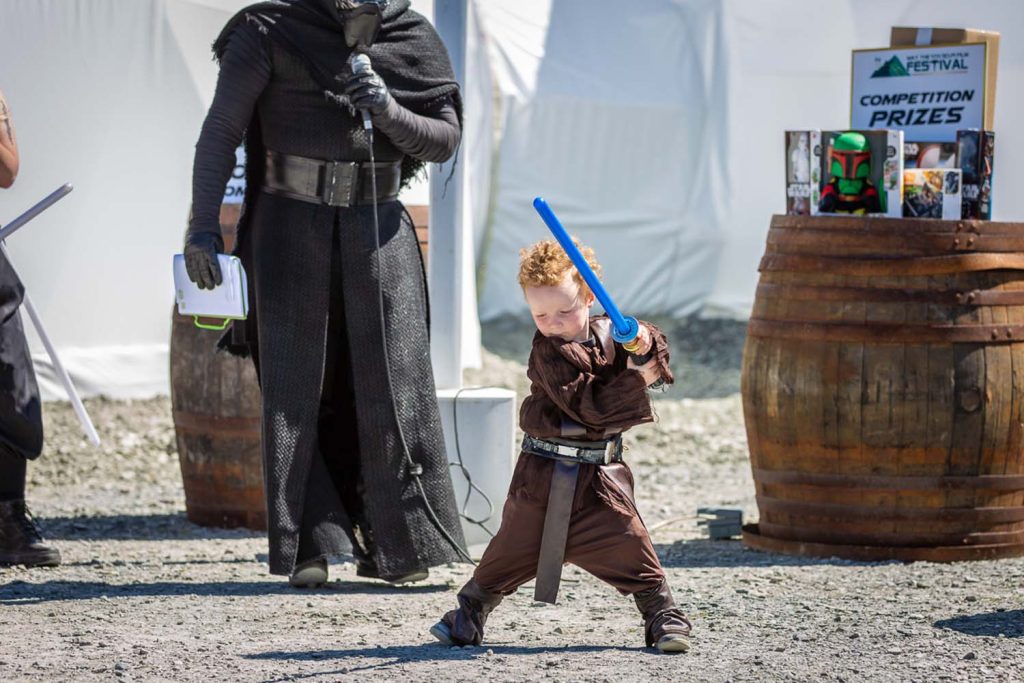 A toddler with a lightsaber