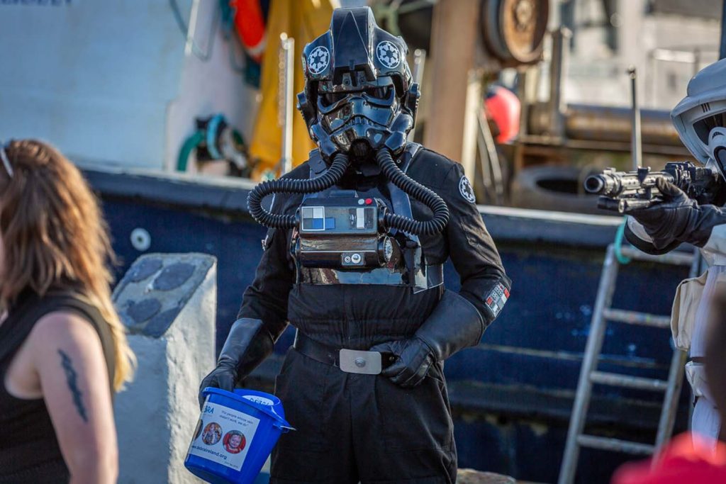 A stormtrooper with a charity bucket