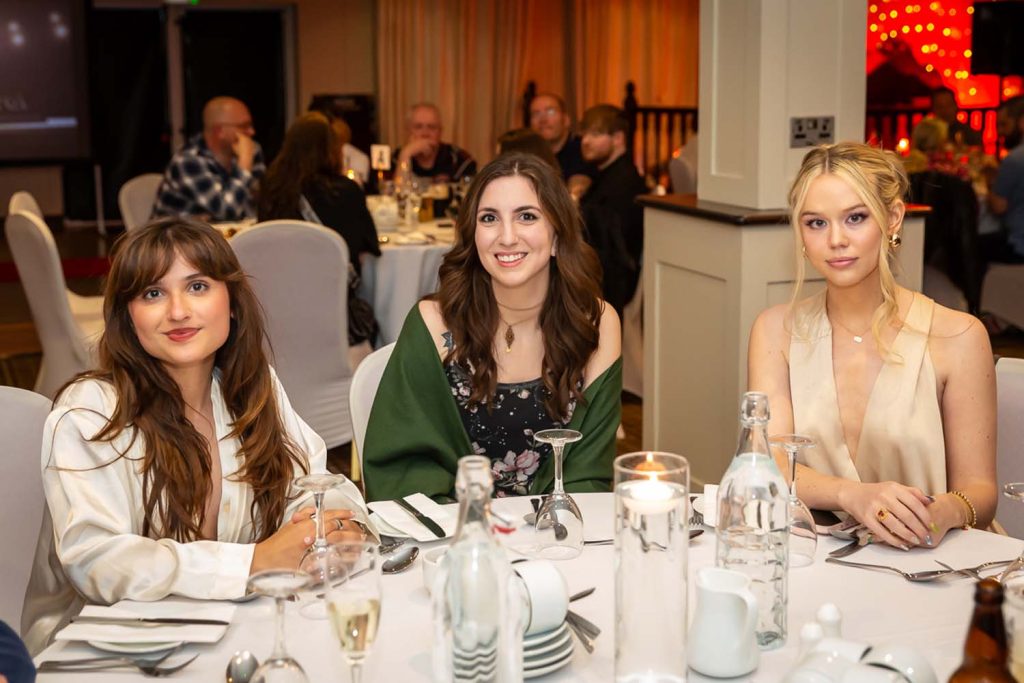 Three ladies attending the awards ceremony