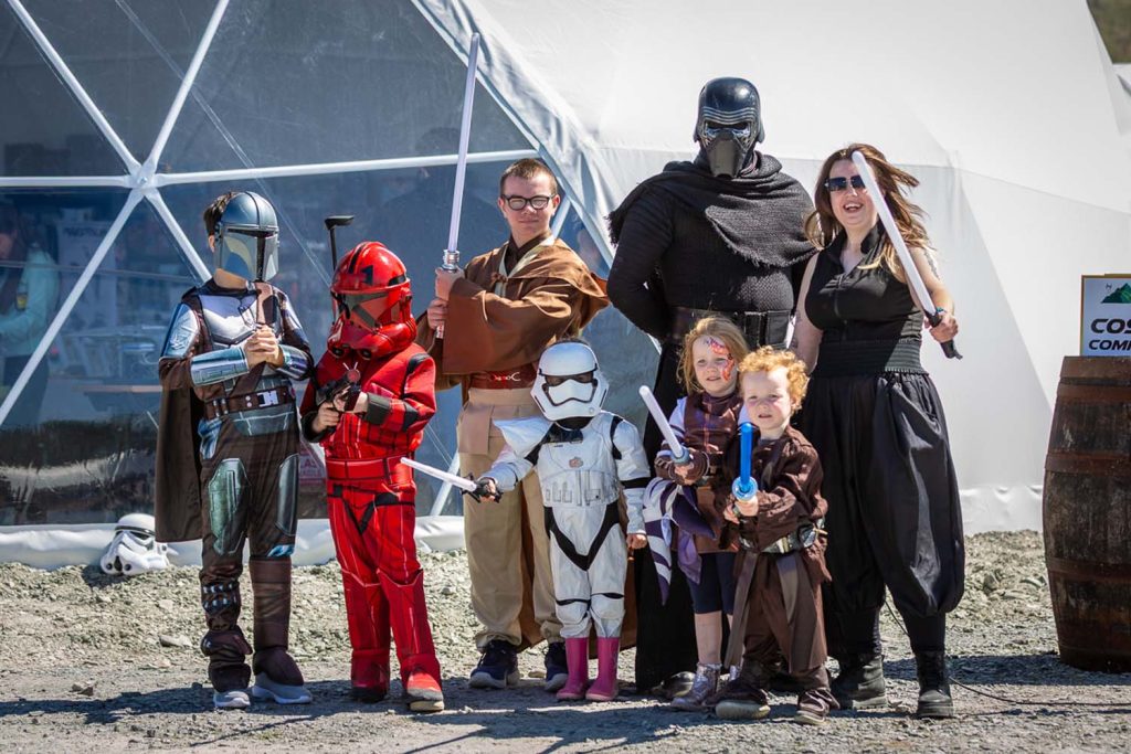 Children posing with a star wars character