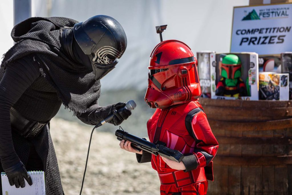 A young child talking into a microphone