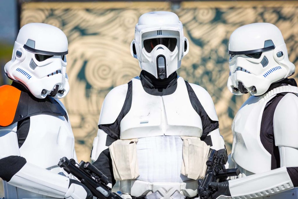 Stormtroopers with different armour posing in front of a mural