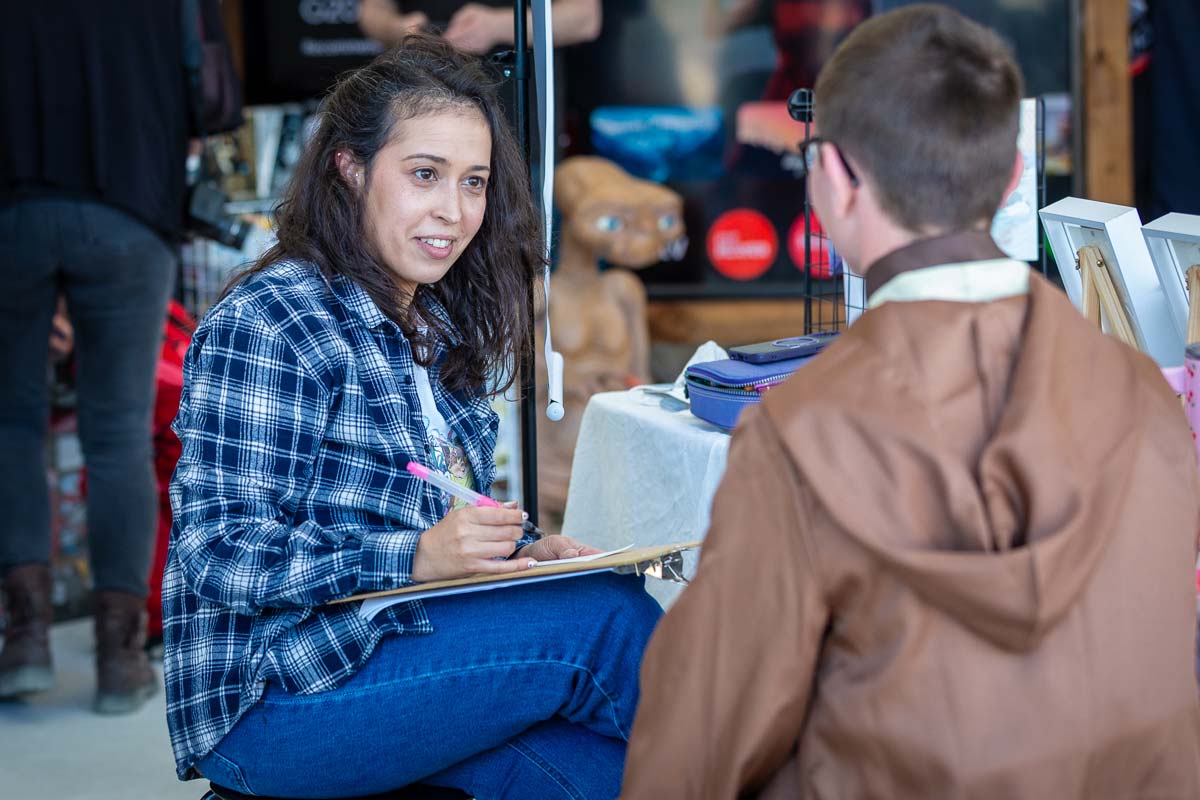 A lady drawing a young boy
